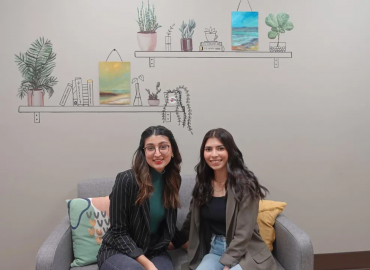 Nuha Siddiqui and Kritika Tyagi sitting on a couch, smiling