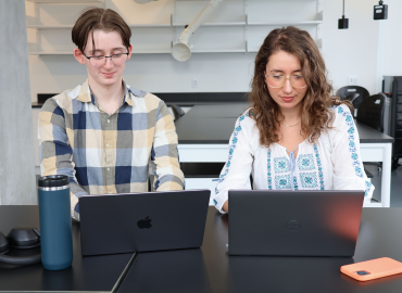 Two students on their computer working